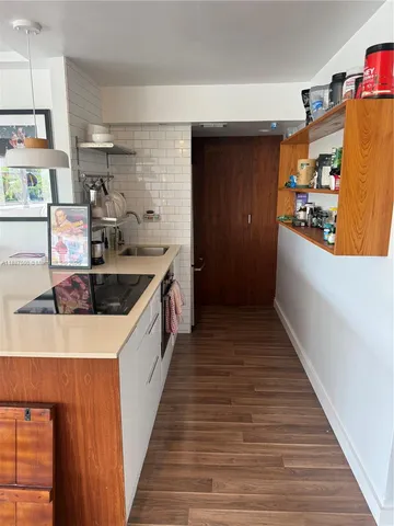 a kitchen with stainless steel appliances granite countertop a sink and wooden cabinets