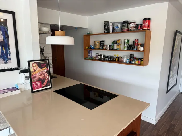 a kitchen with stainless steel appliances a refrigerator and a table