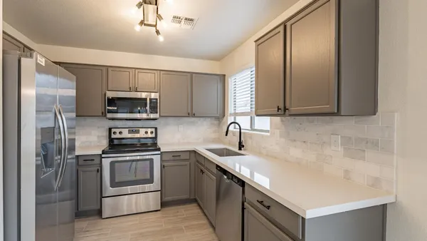 a kitchen with a sink stainless steel appliances and cabinets