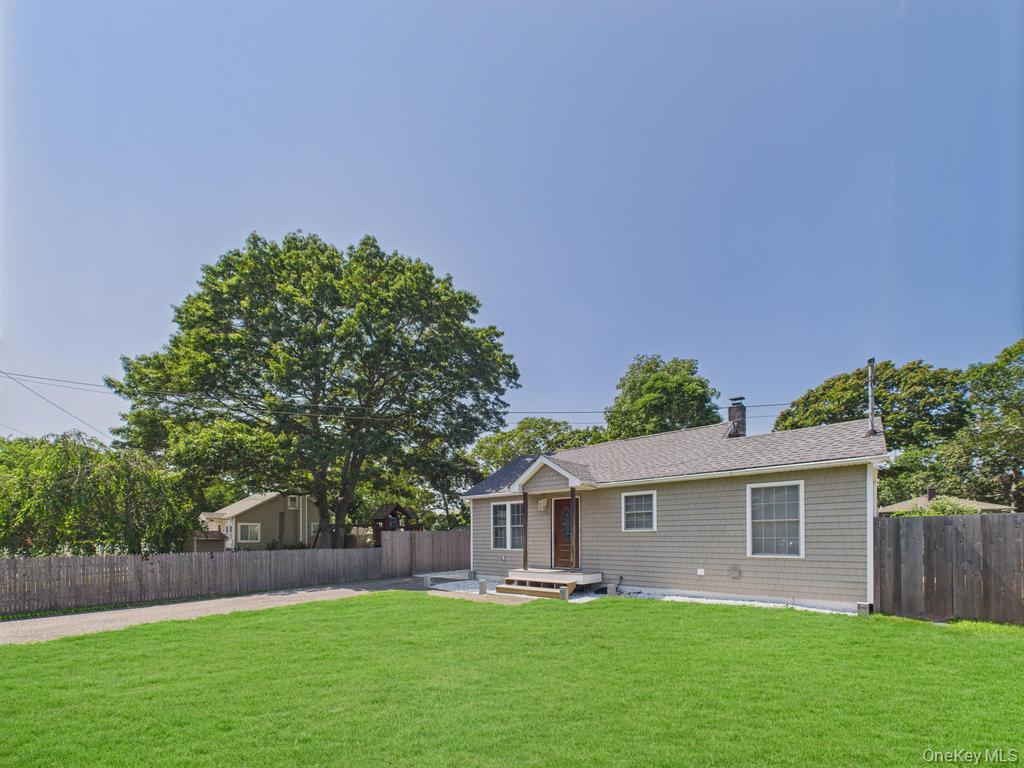 a front view of house with a garden
