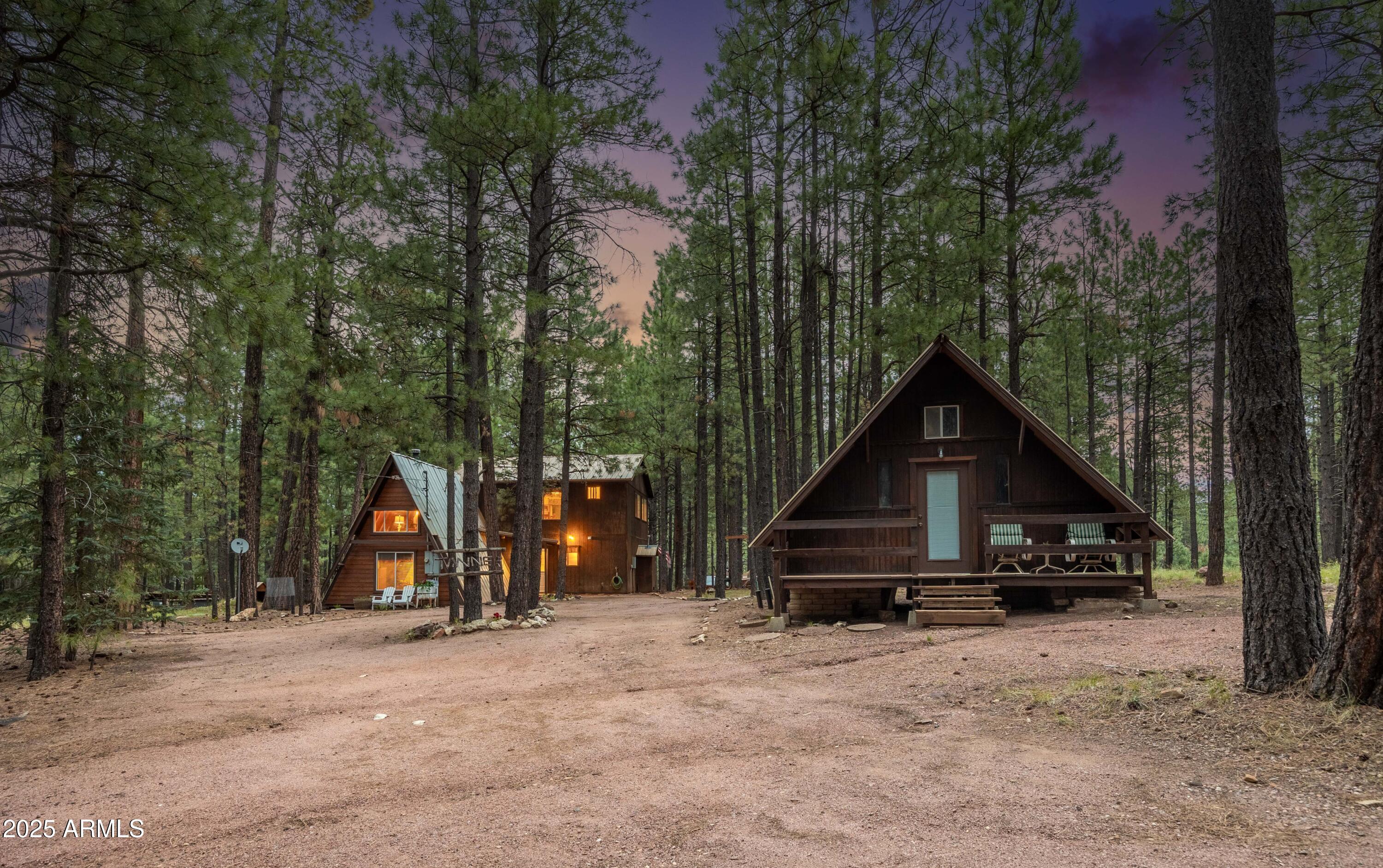 1643 Rifle Way Forest Lakes, AZ 85931 - Photo 3 of 40 a view of wooden house with a big yard and large trees