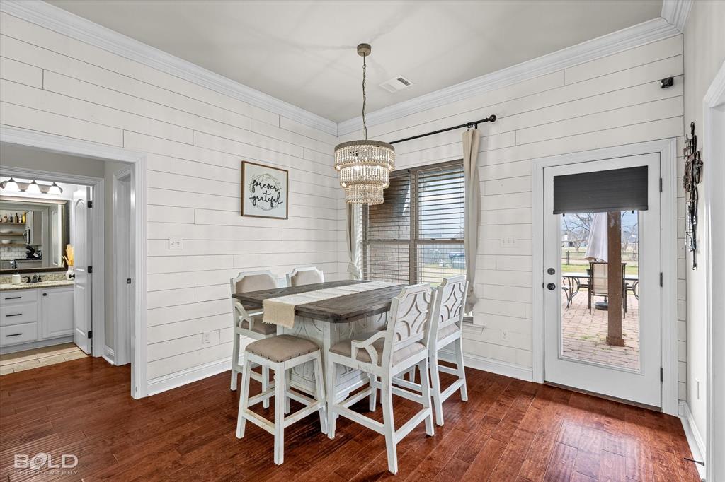946 Maize Street Bossier City, LA 71111 - Photo 25 of 39 a view of a dining room with furniture window and wooden floor