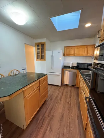 a kitchen with stainless steel appliances granite countertop a stove a sink and a microwave