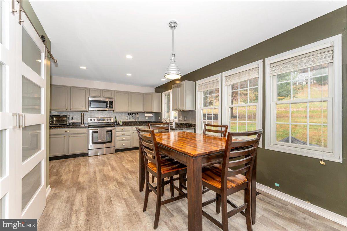 6536 South Clifton Road Frederick, MD 21703 - Photo 16 of 71 a kitchen with stainless steel appliances kitchen island granite countertop white cabinets and wooden floor
