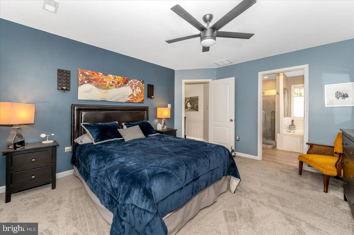 6536 South Clifton Road Frederick, MD 21703 - Photo 28 of 71 a bedroom with a bed and a chandelier