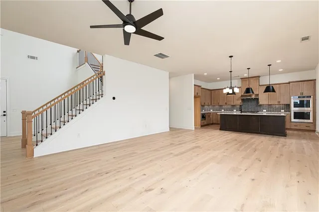 a view of kitchen and hall with wooden floor