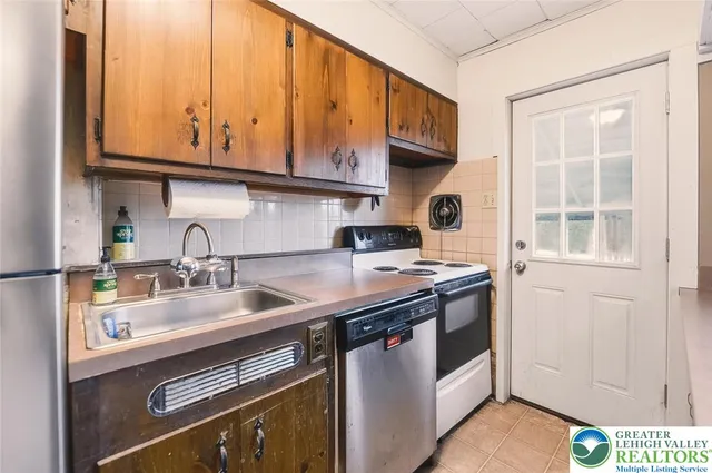 a kitchen with stainless steel appliances granite countertop a sink and a stove