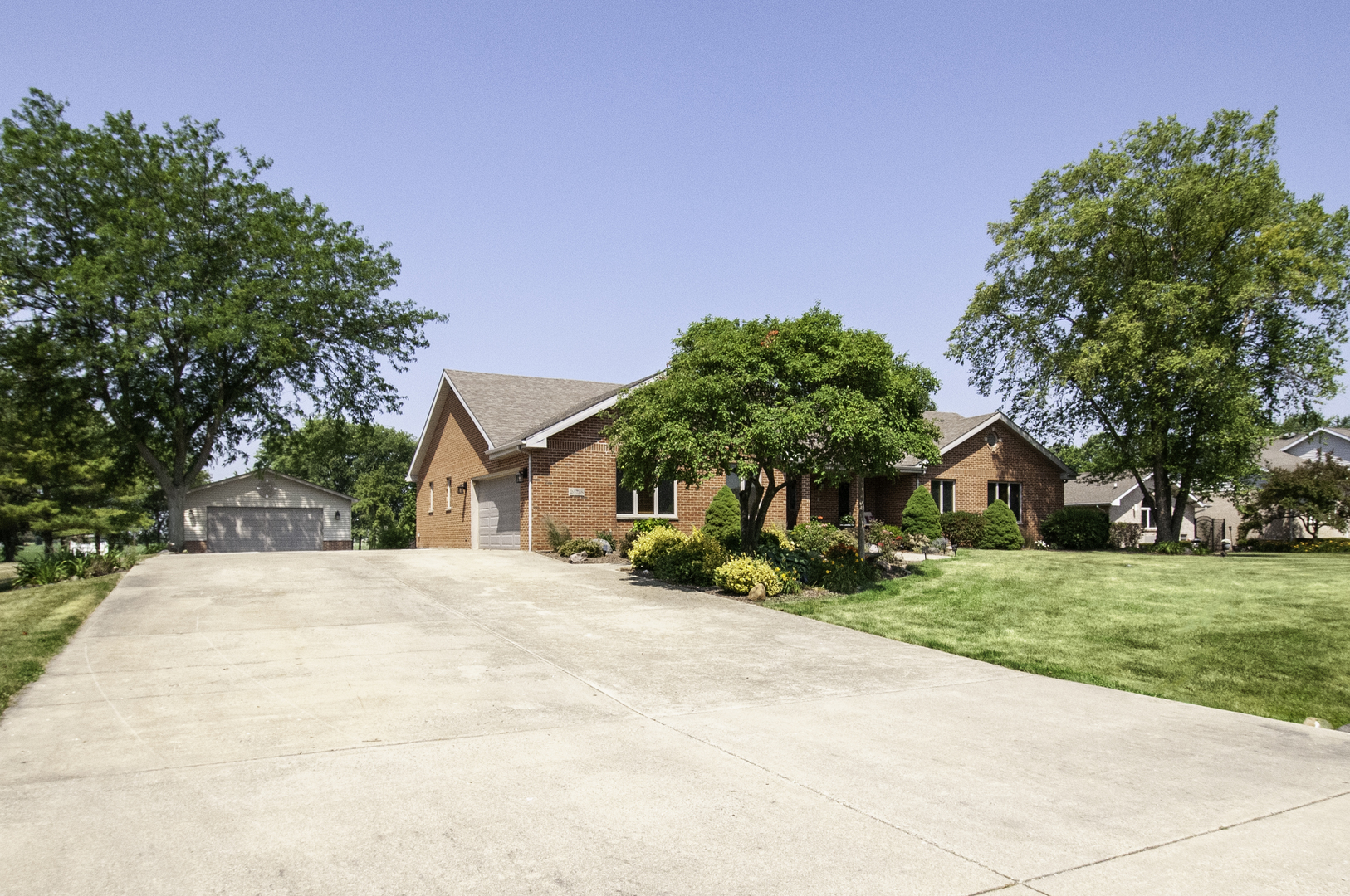 24738 South Walnut Street Elwood, IL 60421 - Photo 2 of 20 a front view of a house with a yard and garage