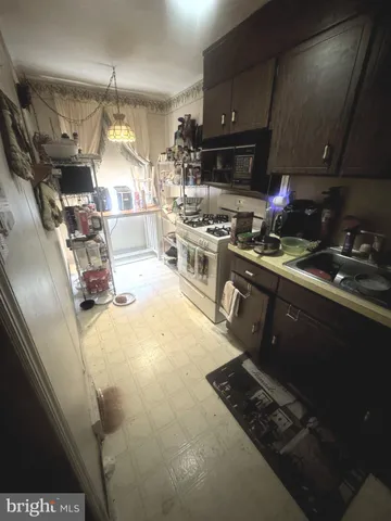 a kitchen with a sink appliances and cabinets