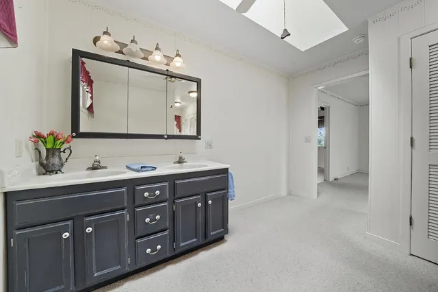 a view of house with backyard and chairs