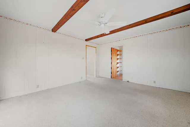 a view of backyard with small cabin and wooden fence