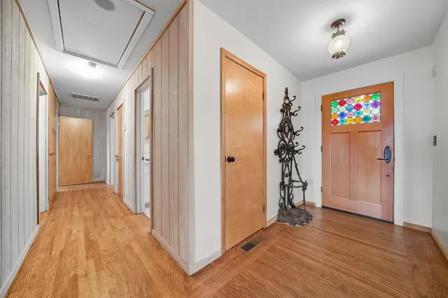 a kitchen with stainless steel appliances granite countertop a dishwasher a stove and a microwave oven with wooden floor