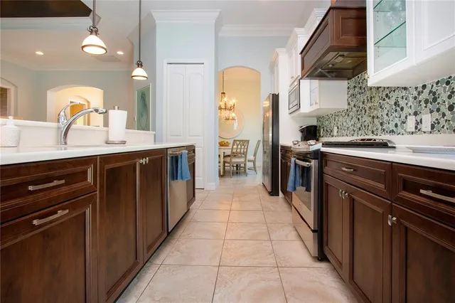 a view of a dining room with furniture and chandelier