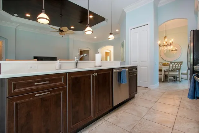 a view of a dining room with furniture and chandelier