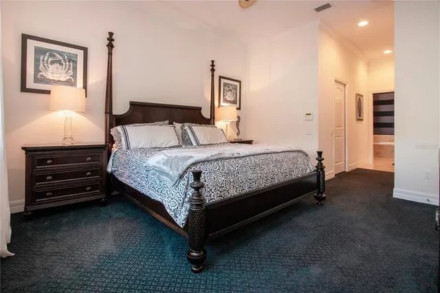 a bedroom with a bed and a mirror