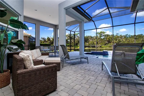 a view of a patio with a table and chairs under an umbrella