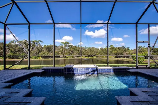 a view of a swimming pool with a yard and lake view
