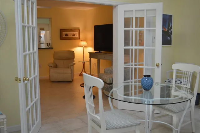 a dining room with furniture and wooden floor
