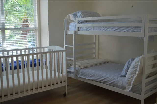 a view of wooden floor and bench in a room