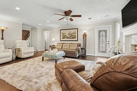 a living room with fireplace furniture and a flat screen tv