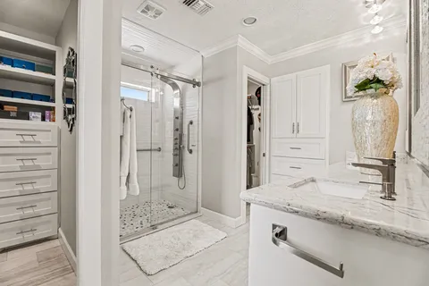 a view of walk in closet with clothes and shoes