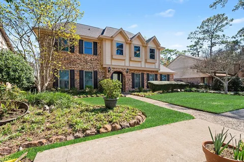 a front view of house with yard and green space