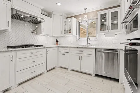 a kitchen with a stove sink and a microwave