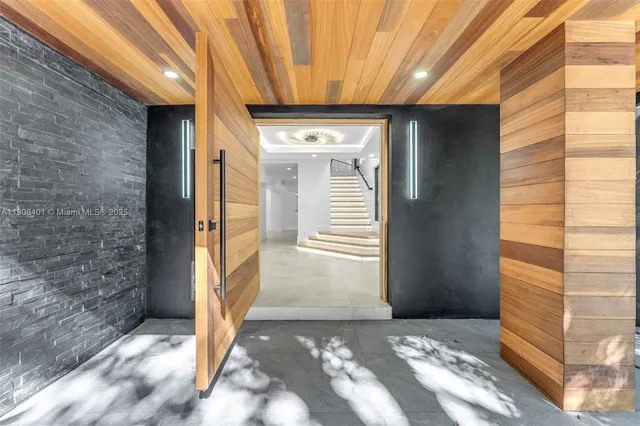 a kitchen with stainless steel appliances kitchen island granite countertop a refrigerator and a sink