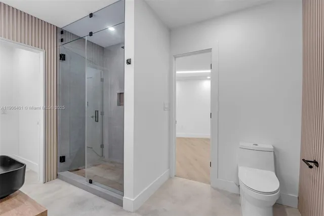 a view of a swimming pool with a patio and plants