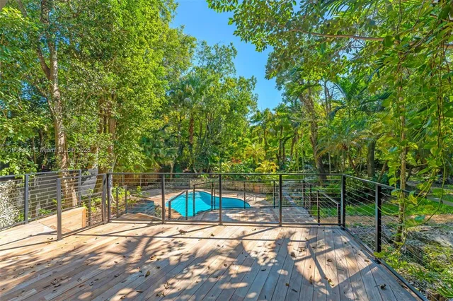 a front view of a house with a yard and a tree