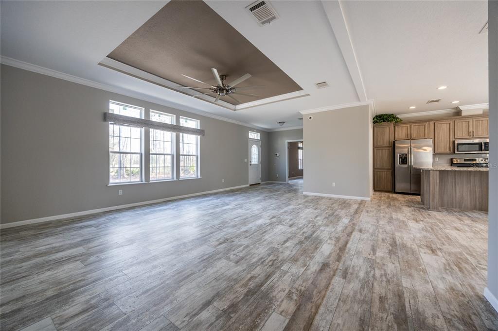 6671 Southwest 128th Lane Lake Butler, FL 32054 - Photo 11 of 66 a view of an empty room with wooden floor and a window