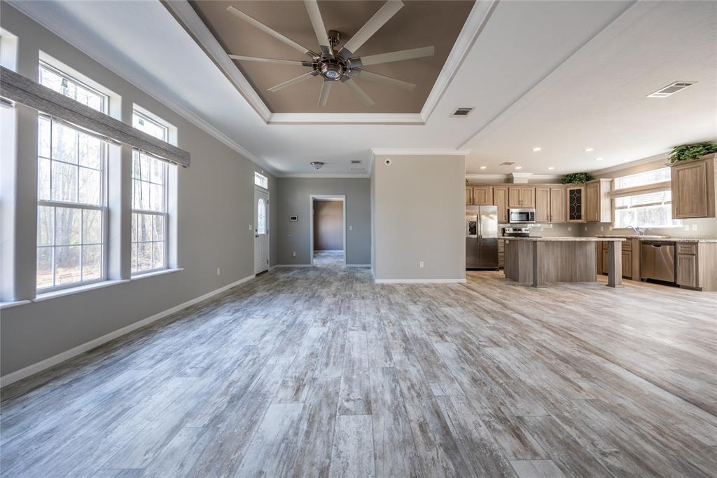 6671 Southwest 128th Lane Lake Butler, FL 32054 - Photo 12 of 66 a view of an empty room with a window and wooden floor