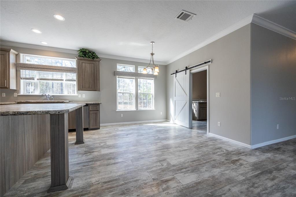 6671 Southwest 128th Lane Lake Butler, FL 32054 - Photo 14 of 66 a view of an empty room with a kitchen and a window
