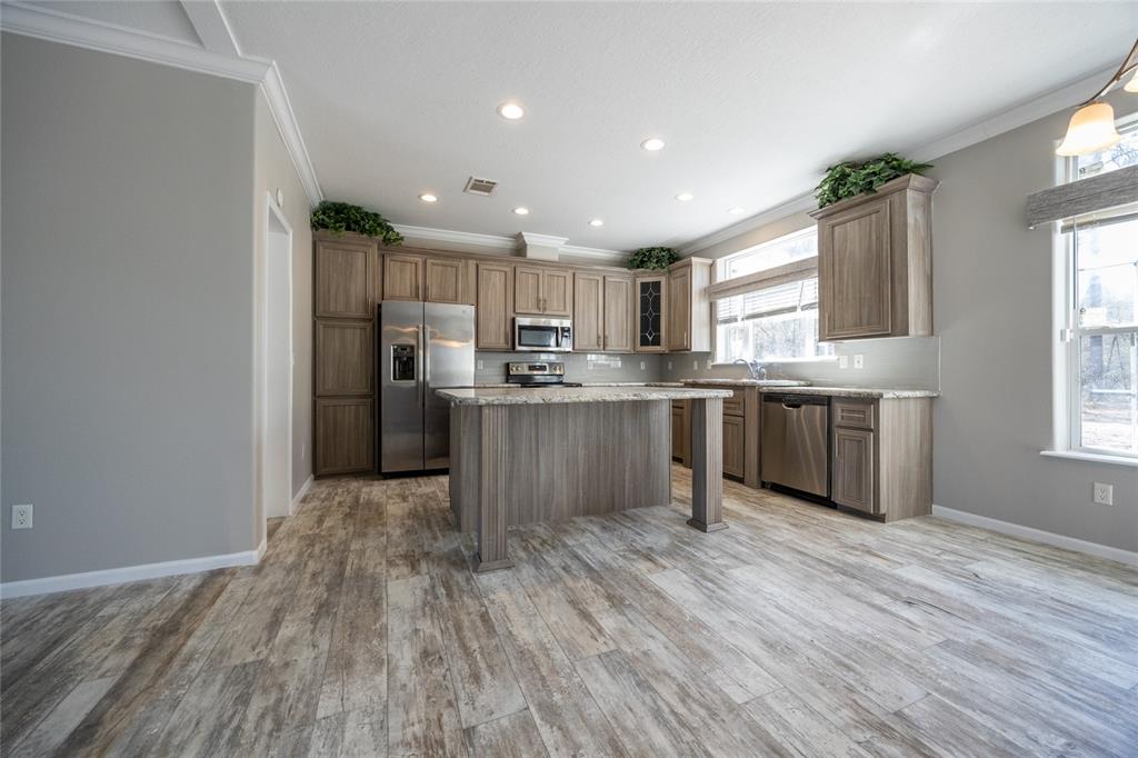 6671 Southwest 128th Lane Lake Butler, FL 32054 - Photo 17 of 66 a kitchen with stainless steel appliances granite countertop a stove a sink dishwasher and a refrigerator