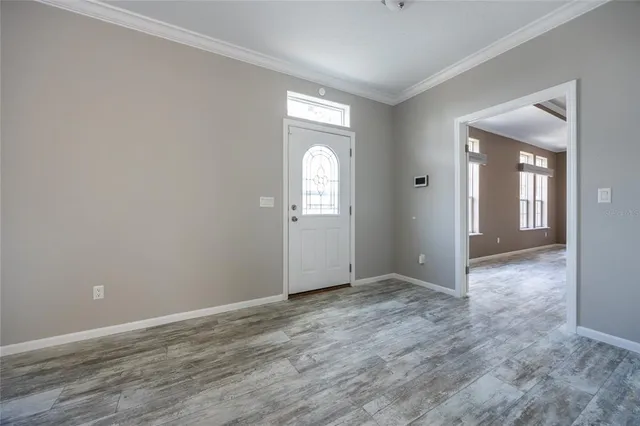 a view of wooden floor and windows in a room