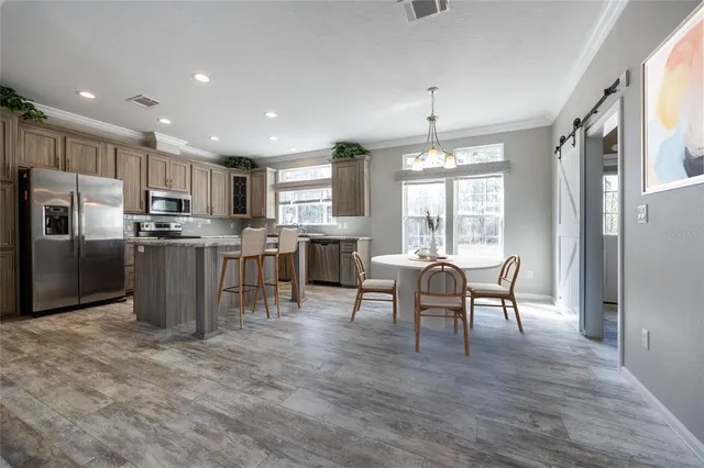 a spacious bedroom with a bed and a flat screen tv