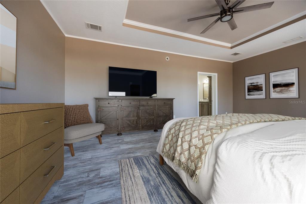 6671 Southwest 128th Lane Lake Butler, FL 32054 - Photo 28 of 66 a spacious bedroom with a bed and a flat screen tv