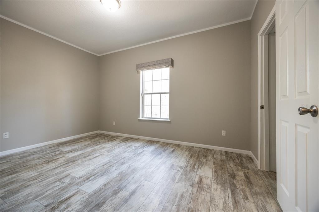 6671 Southwest 128th Lane Lake Butler, FL 32054 - Photo 44 of 66 a view of an empty room with wooden floor and a window