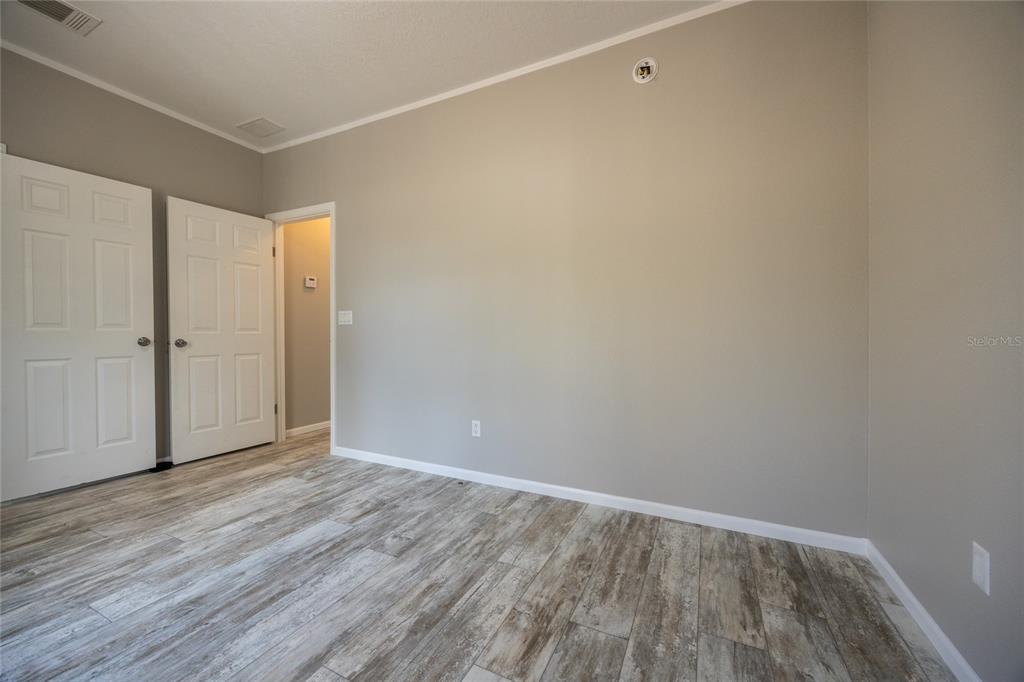 6671 Southwest 128th Lane Lake Butler, FL 32054 - Photo 46 of 66 a view of an empty room with wooden floor