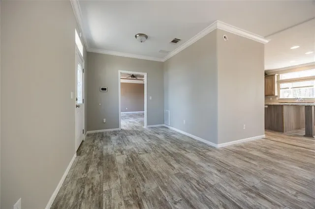 wooden floor in an empty room with a window