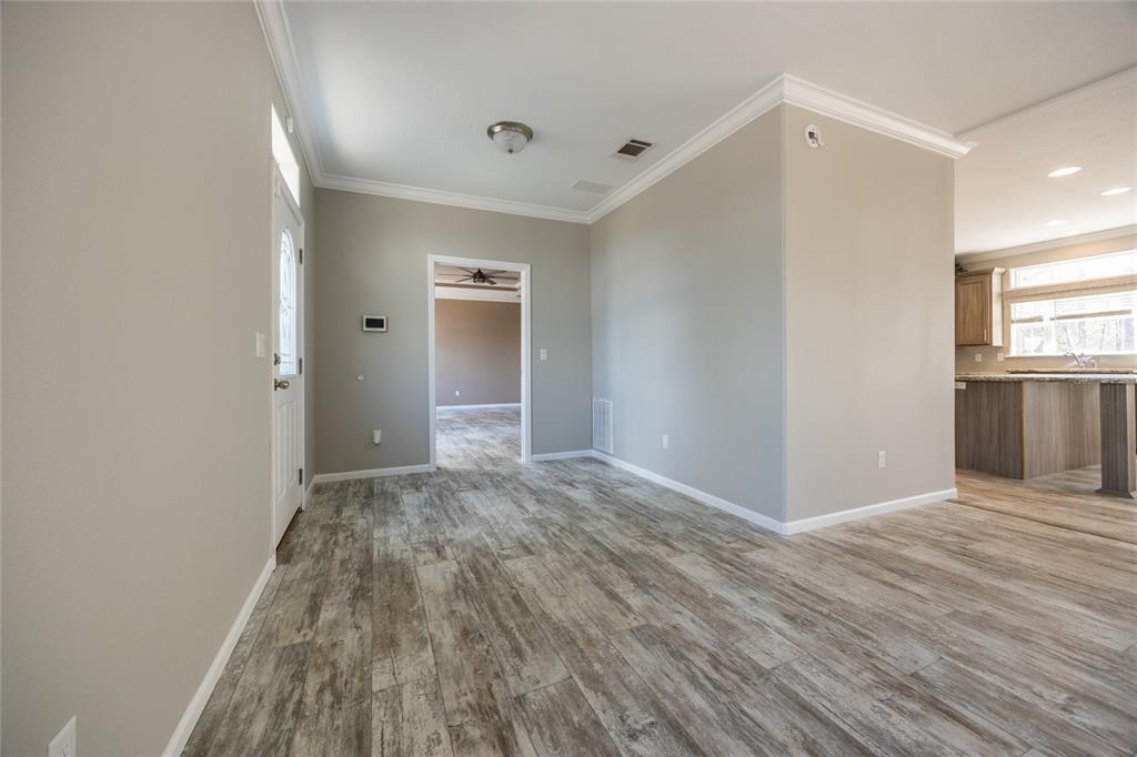 6671 Southwest 128th Lane Lake Butler, FL 32054 - Photo 6 of 66 a view of an empty room with window and wooden floor