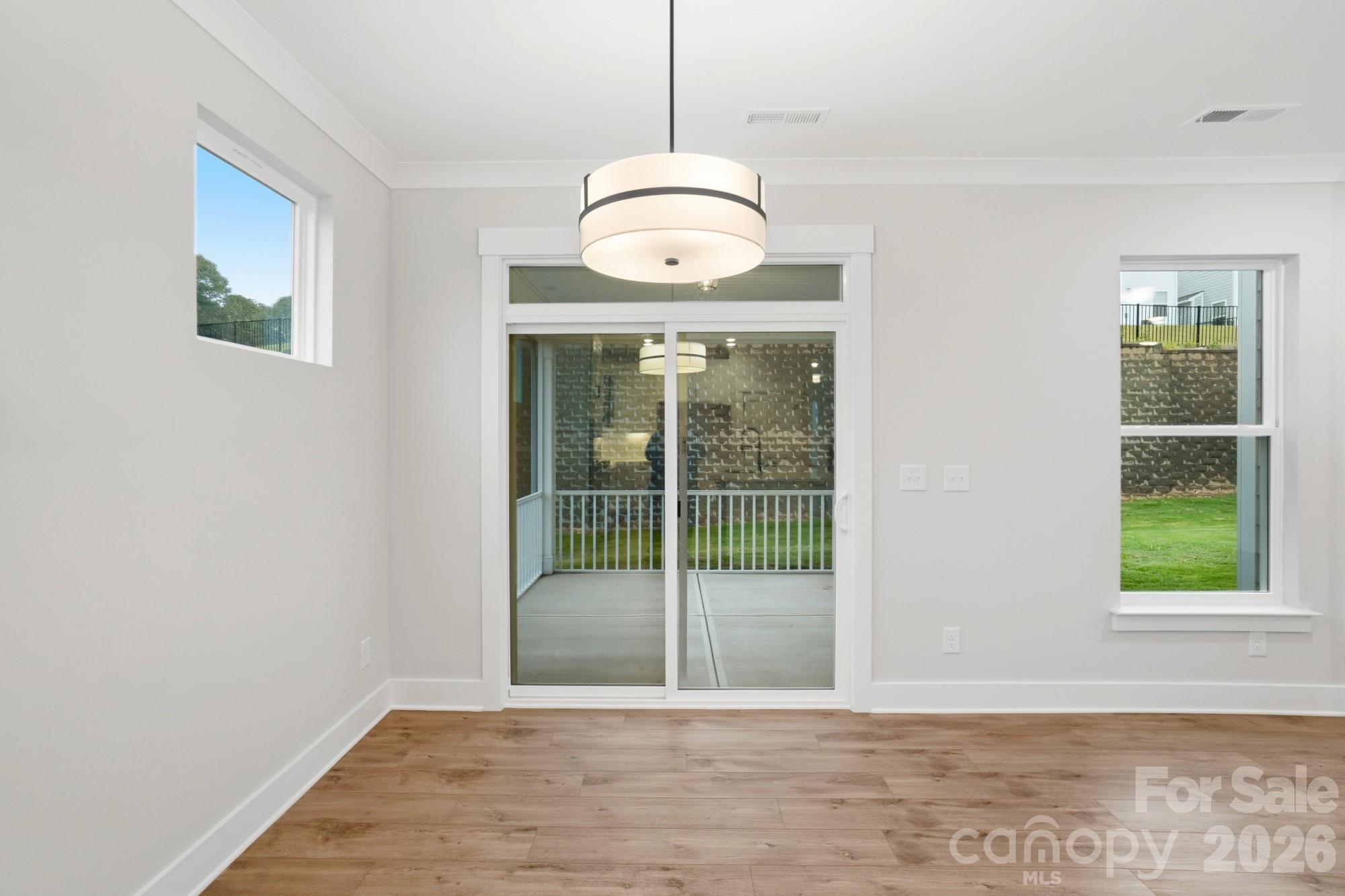 111 Longwood Road Mooresville, NC 28115 - Photo 13 of 47 a view of a room with wooden floor staircase and a ceiling fan