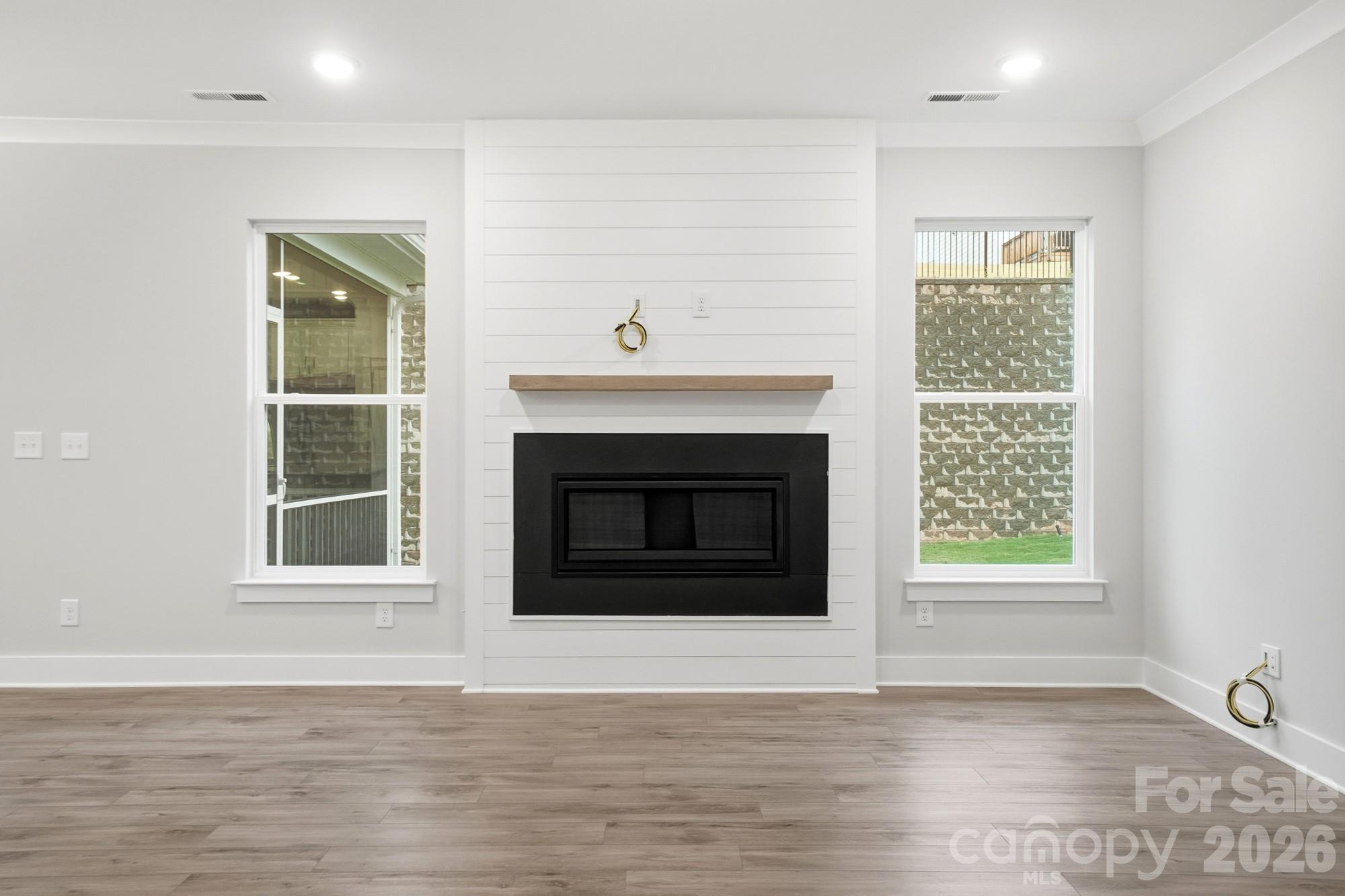 111 Longwood Road Mooresville, NC 28115 - Photo 16 of 47 a view of an empty room with wooden floor and a window