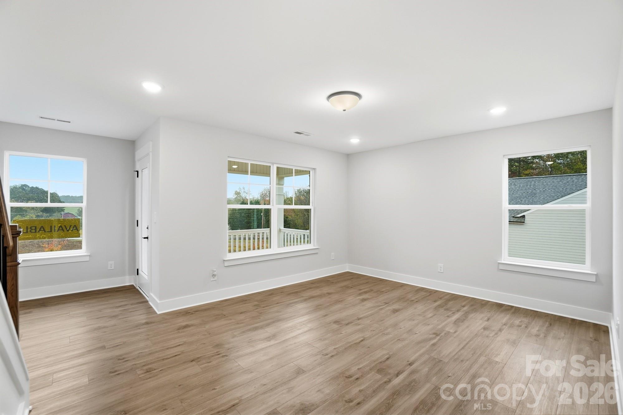 111 Longwood Road Mooresville, NC 28115 - Photo 35 of 47 an empty room with wooden floor and windows