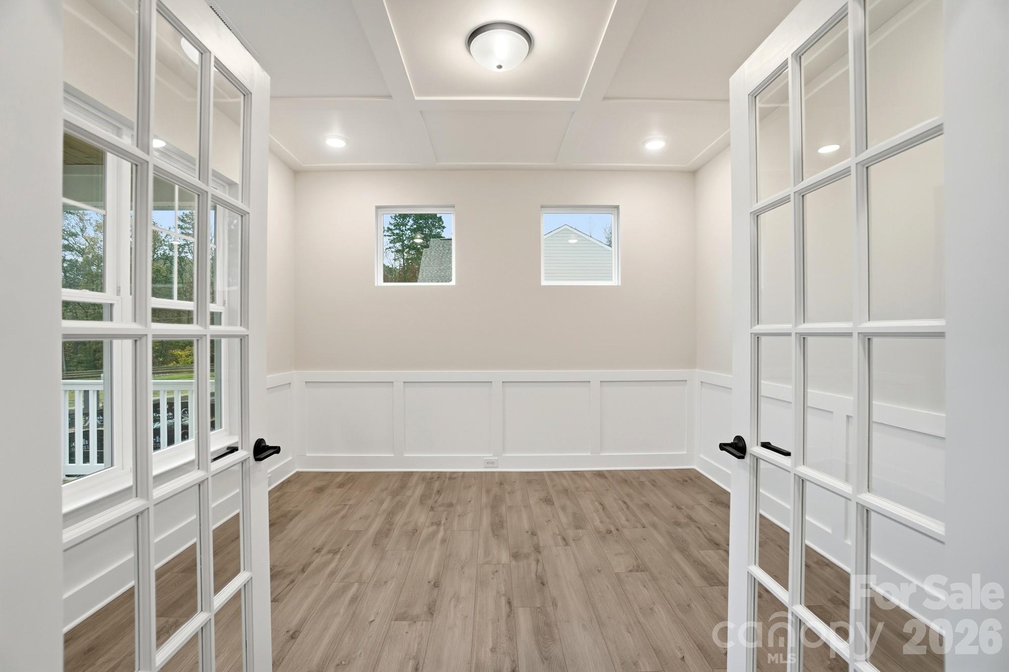 111 Longwood Road Mooresville, NC 28115 - Photo 7 of 47 an empty room with wooden floor and windows