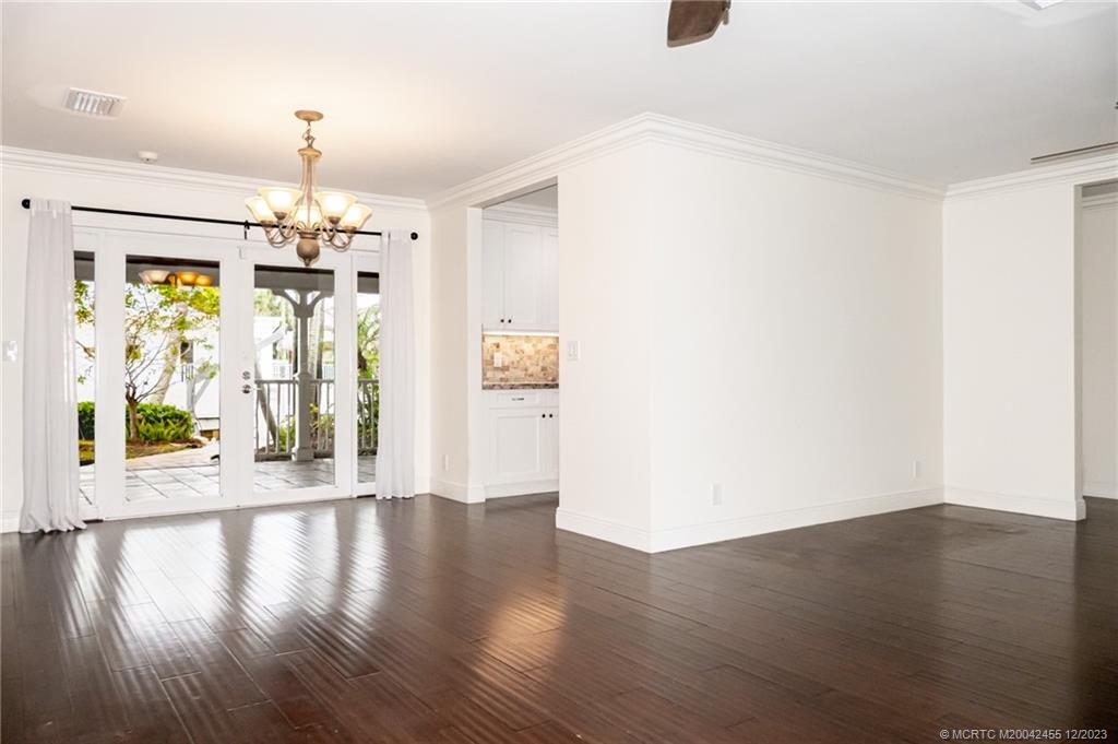 18014 Perigon Way Jupiter, FL 33458 - Photo 13 of 34 wooden floor in an empty room with a window