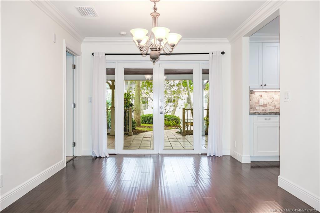 18014 Perigon Way Jupiter, FL 33458 - Photo 14 of 34 a view of an empty room with wooden floor and a window