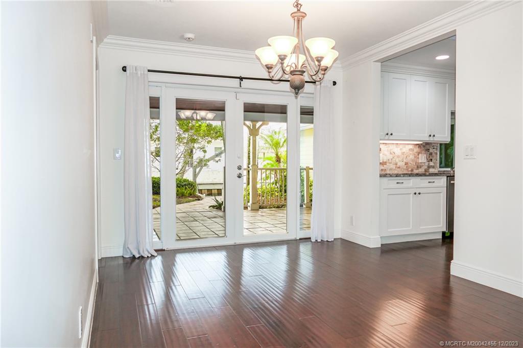 18014 Perigon Way Jupiter, FL 33458 - Photo 15 of 34 a view of a big room with wooden floor chandelier and windows