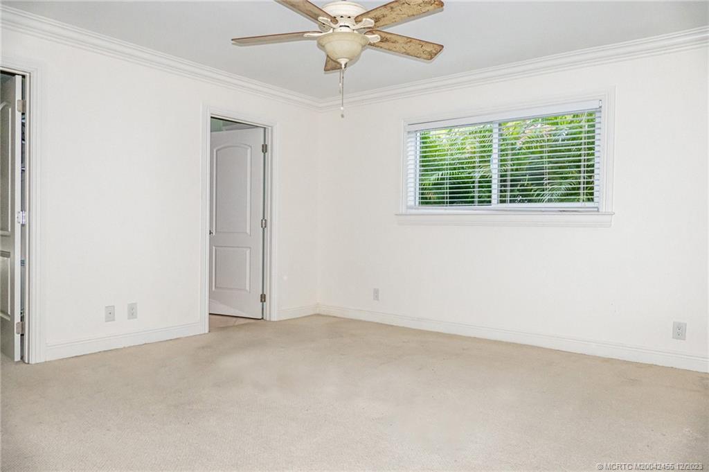 18014 Perigon Way Jupiter, FL 33458 - Photo 19 of 34 an empty room with a window and a fan