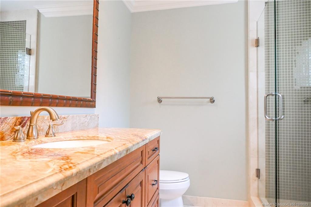 18014 Perigon Way Jupiter, FL 33458 - Photo 21 of 34 a bathroom with a granite countertop sink and a toilet